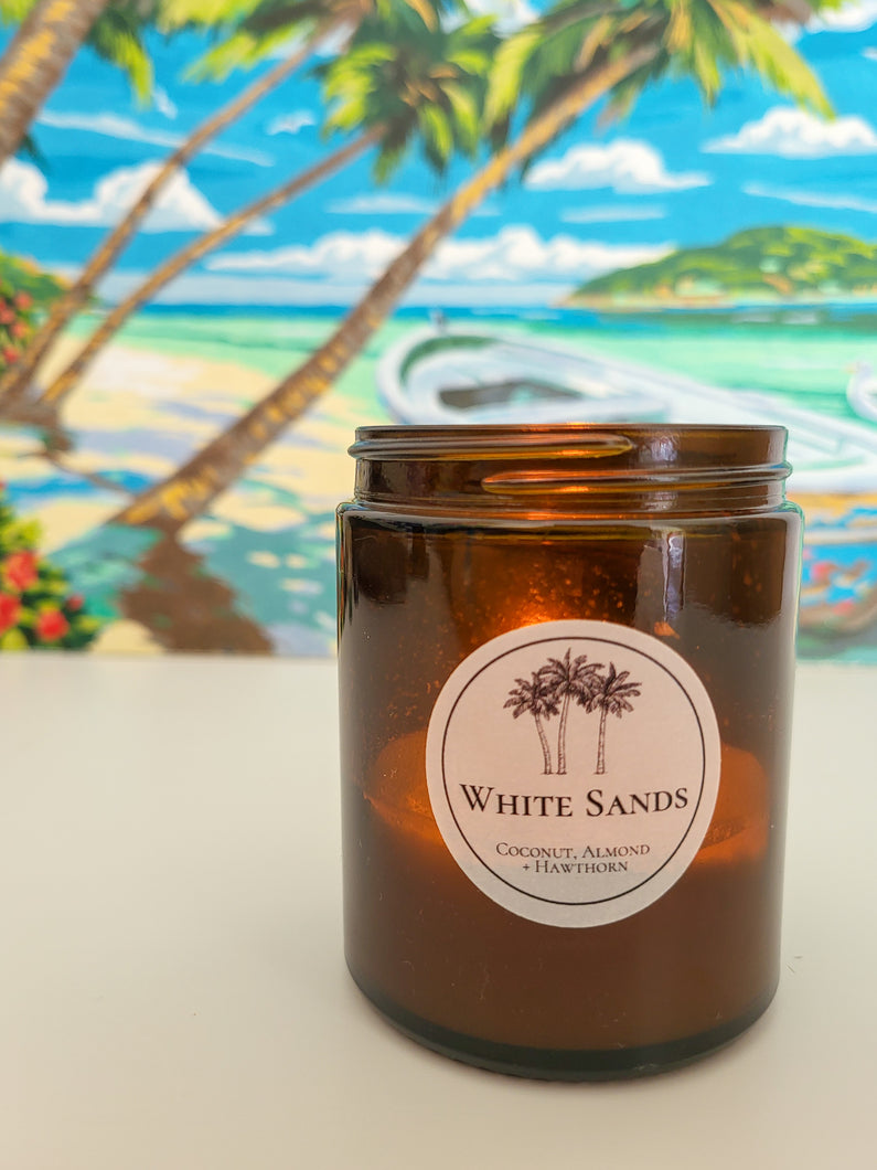 candle with tropical scene behind