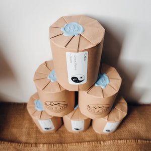candles packaged in brown paper, pale blue wax stamp sealing them